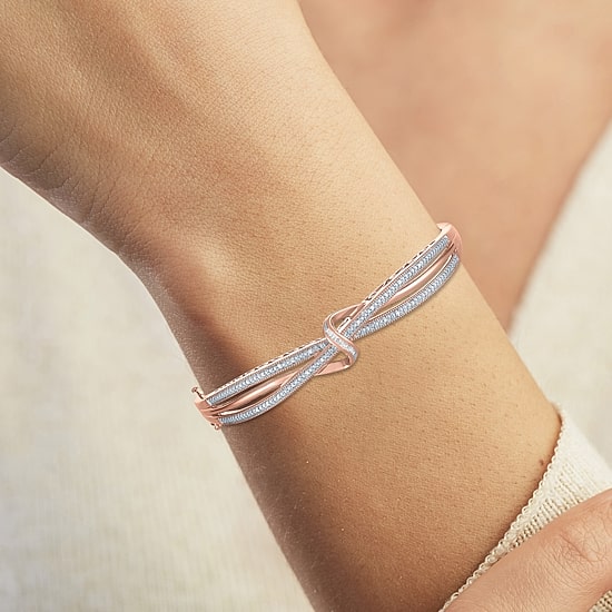 1/10 CT. T.W. Diamond Crossover Bangle Bracelet in Sterling Silver or 14K Gold Over Silver